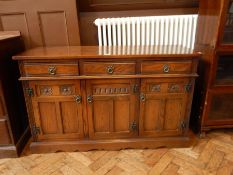 A 19th century style 'Old Charm Furniture' reproduction sideboard with three short drawers and