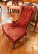 A late Victorian walnut framed nursing chair, with button back, upholstered stuffover seat,