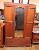 A mahogany bedroom suite viz: a double wardrobe with mirror centre panel, frieze drawer,