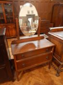 An oak dressing table with integral swing mirror over two long drawers, 93cm wide,