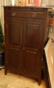 An Edwardian mahogany sheet music cabinet with one drawer above panelled cupboard doors,