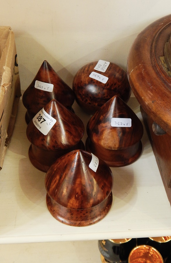 A collection of Moroccan decorative thuya wood to include four conical topped and one circular