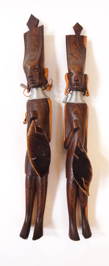 Two carved hardwood figures of tribal men holding a shield and one with spear
