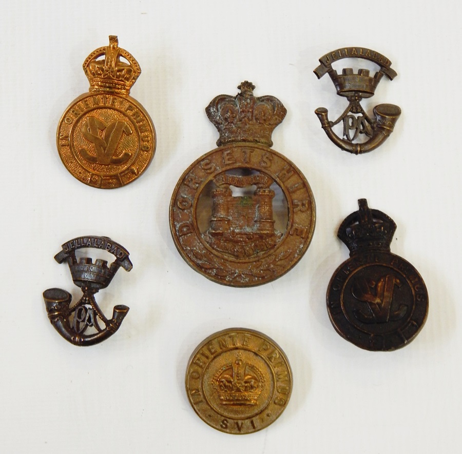 Two cap badges for the Singapore Volunteer Corp, another,