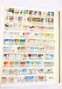 Thousands of worldwide used stamps in blue album