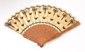 A Chinese wooden brise fan, both guard sticks slightly damaged,