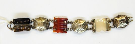 Victorian silver and agate bracelet having three carved scalloped and shaped rectangular agate