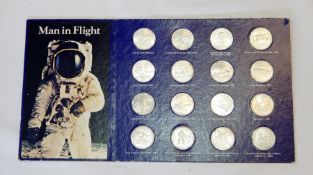A large collection of coins to include historic cars, man in flight,