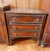 An oak chest of three drawers with beaded borders, teardrop handles, on square supports and castors,