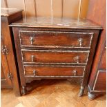 An oak chest of three drawers with beaded borders, teardrop handles, on square supports and castors,