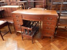 A mahogany serpentine fronted kneehole desk with four flanking drawers,