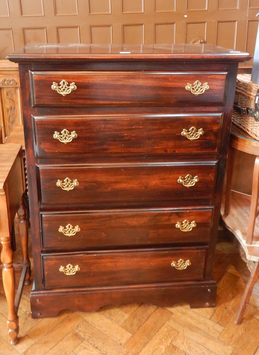 An stained chest of five graduated drawers, on shaped bracket feet,
