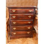An stained chest of five graduated drawers, on shaped bracket feet,