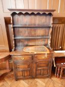 An oak dresser with open plate racks,