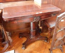 A 19th century mahogany swivel top card table on octagonal pillar and an oak florally carved