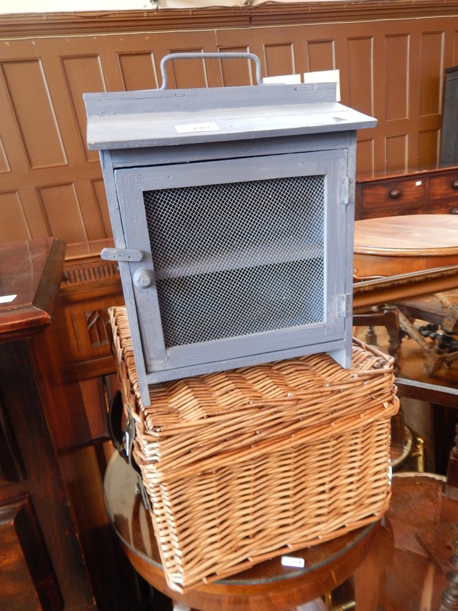 A blue painted mesh fronted storage box, a wicker basket,