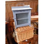 A blue painted mesh fronted storage box, a wicker basket,