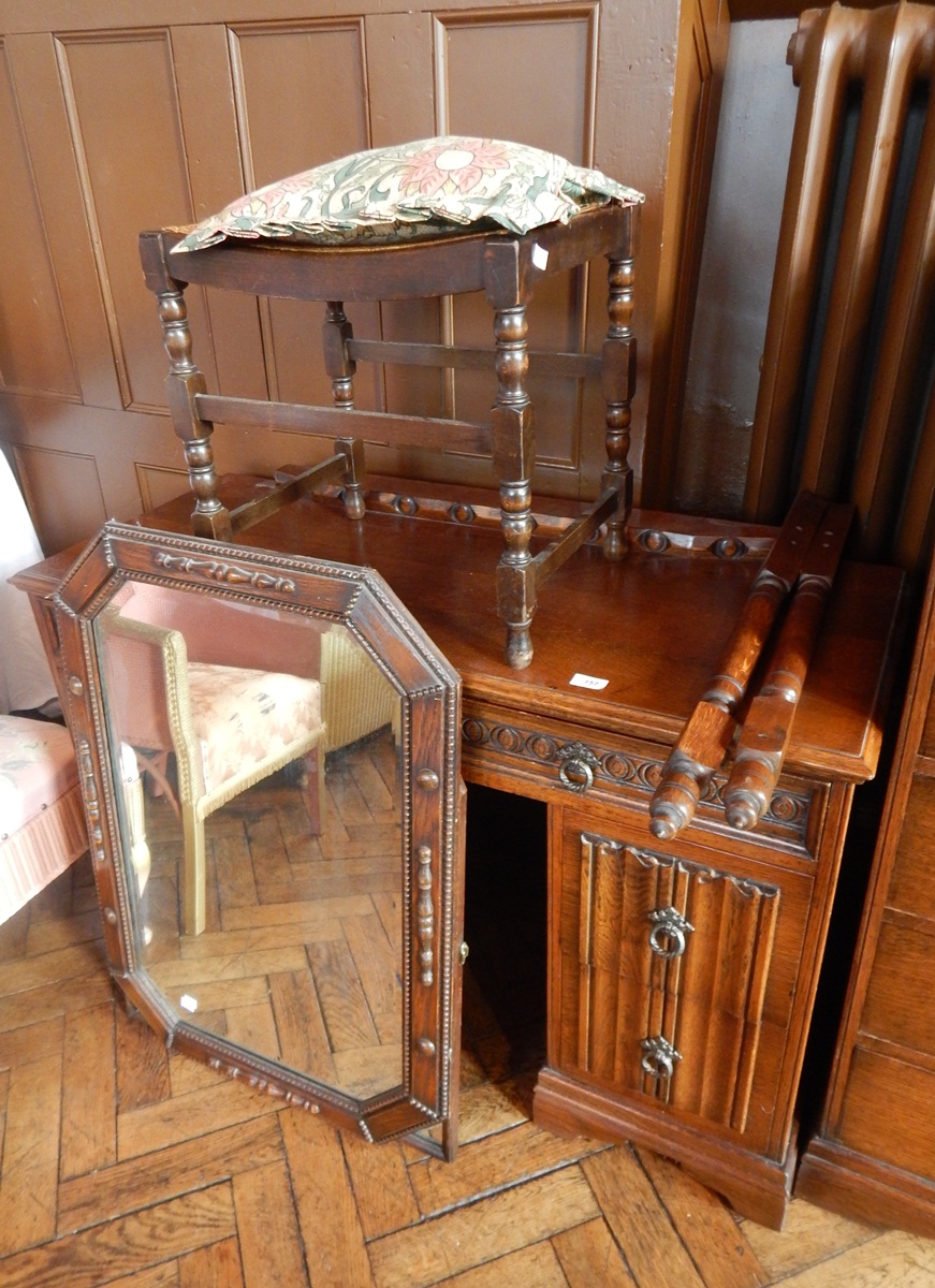 An oak bedroom suite with linenfold carving, viz:- double wardrobe, two bedside cabinets,