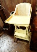 A 20th century yellow high chair with foot rest and undershelf,