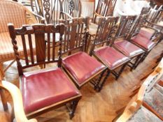 A set of six oak dining chairs (five standards and one carver) with lathe backs,