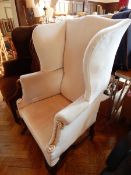A Georgian style wing back armchair upholstered in grey dralon,