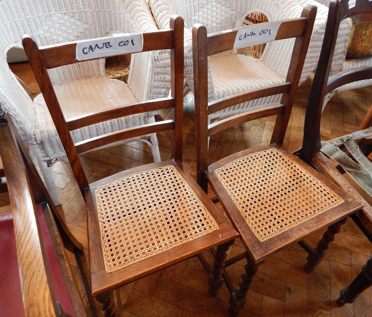A pair of oak bedroom chairs with cane seats,