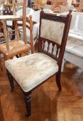 A dining chair with floral pattern to cross rail, column supports and reeded edges,