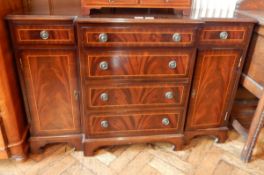 A breakfront mahogany sideboard with two flanking drawers and cupboards,