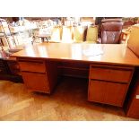 A Heals 1950's teak kneehole desk with four flanking drawers,