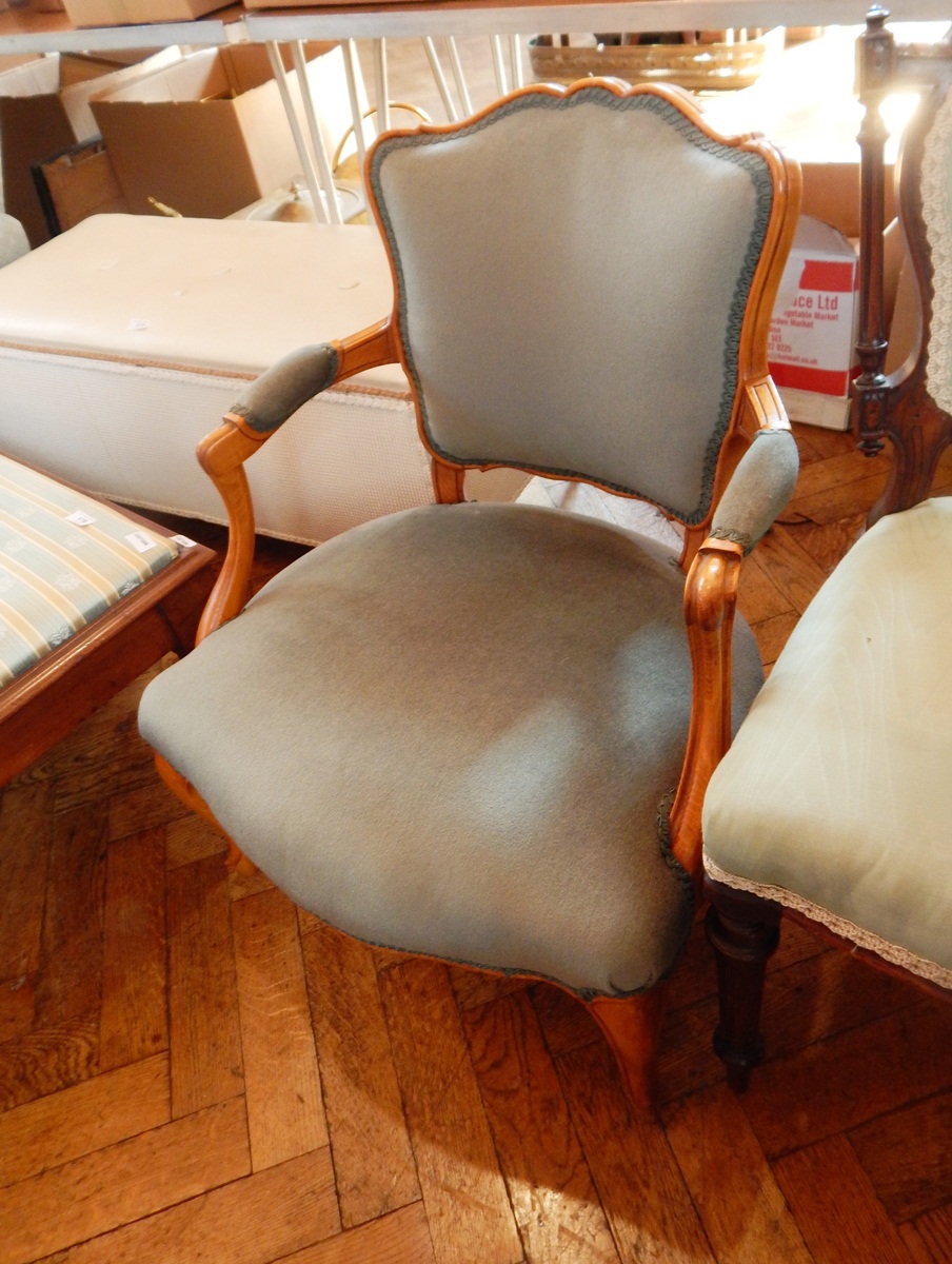 A 20th century open armchair with green fabric cushion