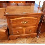 A stained small chest with one long and two short drawers, on shaped bracket feet,