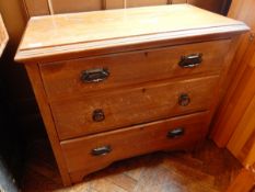 An oak chest of three graduated drawers, on shaped bracket feet,