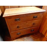 An oak chest of three graduated drawers, on shaped bracket feet,