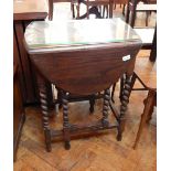 An oak gateleg table with spirally turned supports,