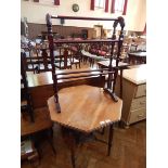 A walnut octagonal top table on bobbin and tapering supports, united by cross stretcher,