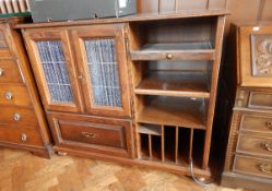 An oak side cabinet with two drawers and storage, on bun feet,
