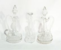 Pair of cut glass wine ewers and stoppers and a small decanter and stopper