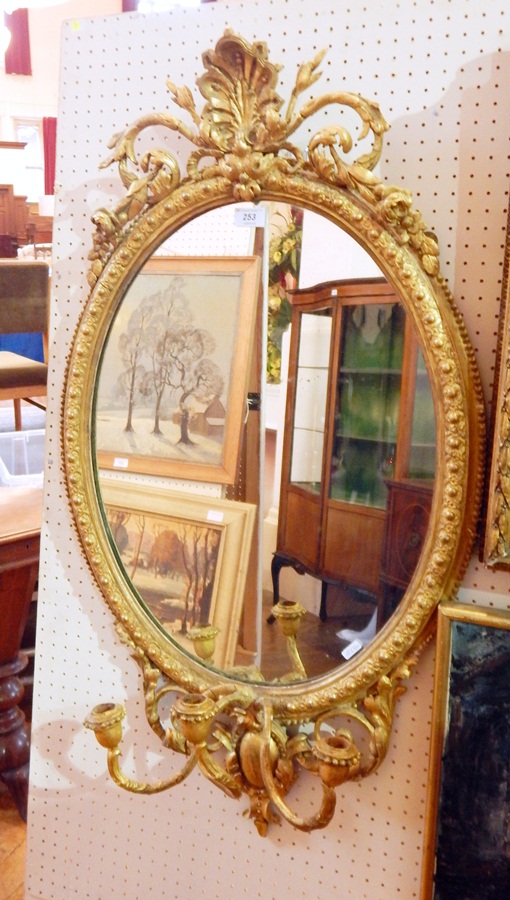 A Georgian style giltwood girandole mirror with carved foliate decoration,