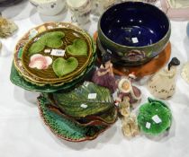 A quantity of various majolica plates with flower, leaf and vine decoration,