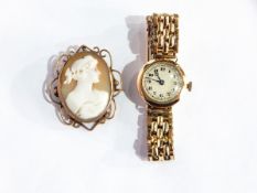 A lady's 9ct gold wristwatch on plated strap and 9ct gold cameo brooch