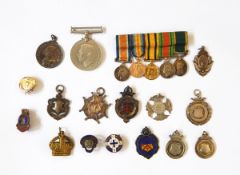 A collection of nine silver fobs including a Victorian example, two enamel examples,