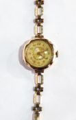 9ct gold lady's wristwatch with engine-turned decorative dial, having Arabic numerals,