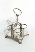 A George IV silver four bottle condiment stand raised on palmette feet, London 1828,