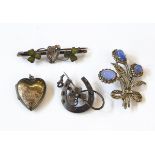 A silver floral spray brooch, the blue cabochon set in a marcasite surround,