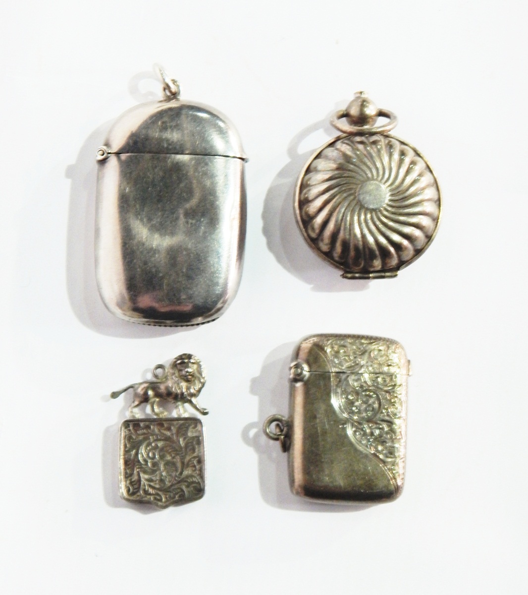 Two Victorian silver vesta cases, one of plain oval form, the other with engraved decoration,