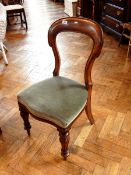 A pair of Victorian mahogany balloon back dining chairs, carved scrollwork supports,