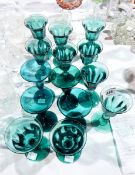Ten green glass faceted cordial glasses with knop stem and four further plain green glass small