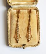 A pair of gold drop earrings, each with a central band of seedpearls, marked 9ct,