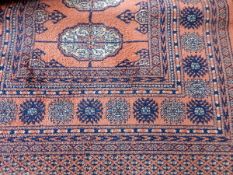 Eastern wool runner with terracotta ground with blue and cream geometric design,