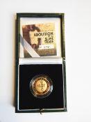 A Royal Mint 2007 gold proof £2 coin commemorating the abolition of the slave trade in 1807,
